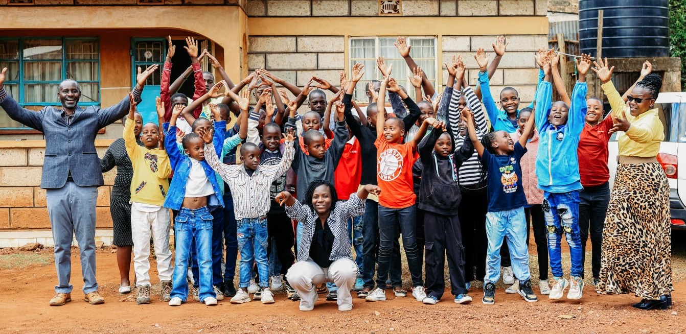 The Macecall Family with hands raised in celebration.